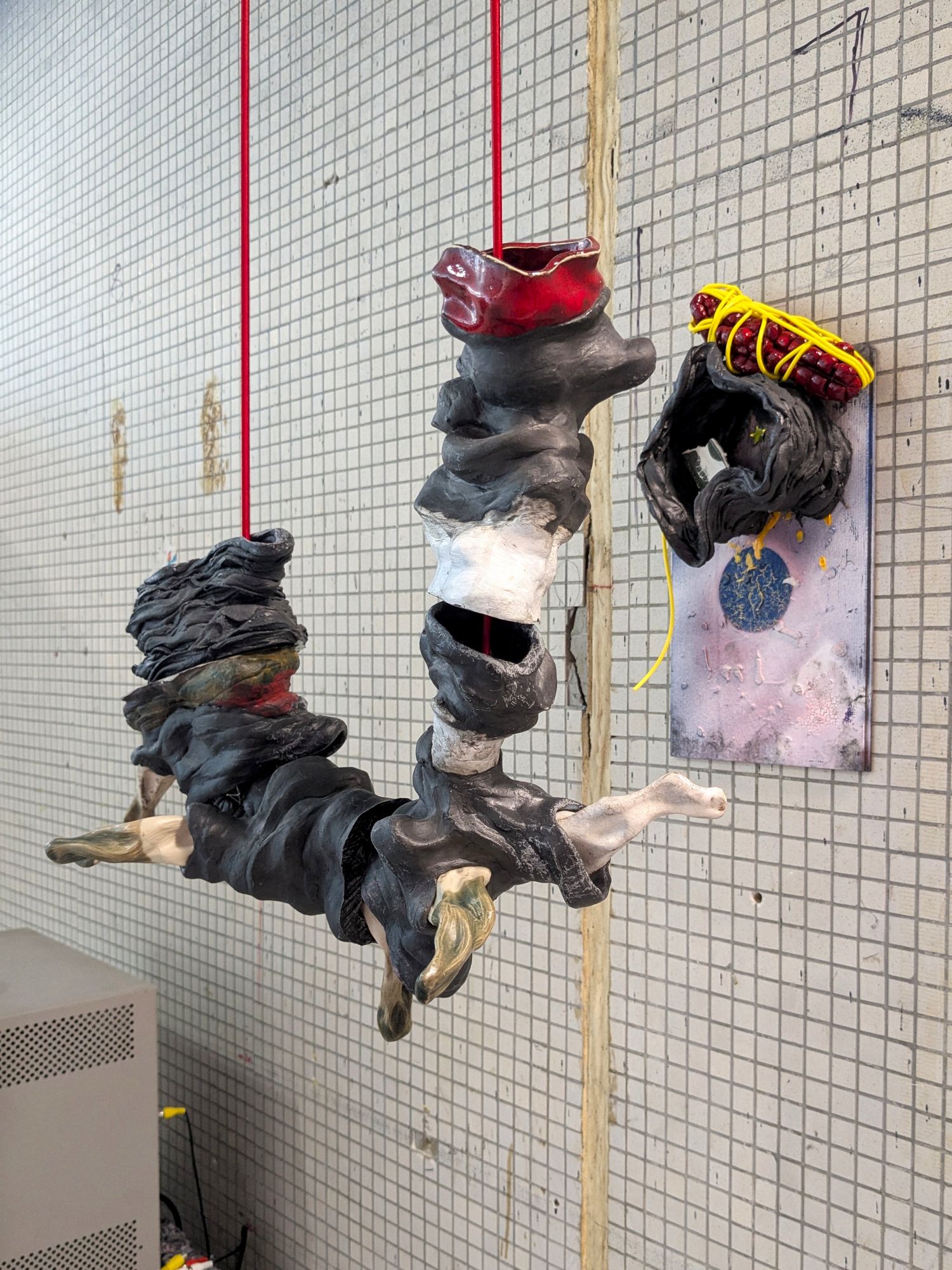 And Endogenidia was his name-o, 2025.
Materials: Epoxy, glazed ceramic, steel, sticker, flooring sample, rubber tube, paint, bungee cord.

