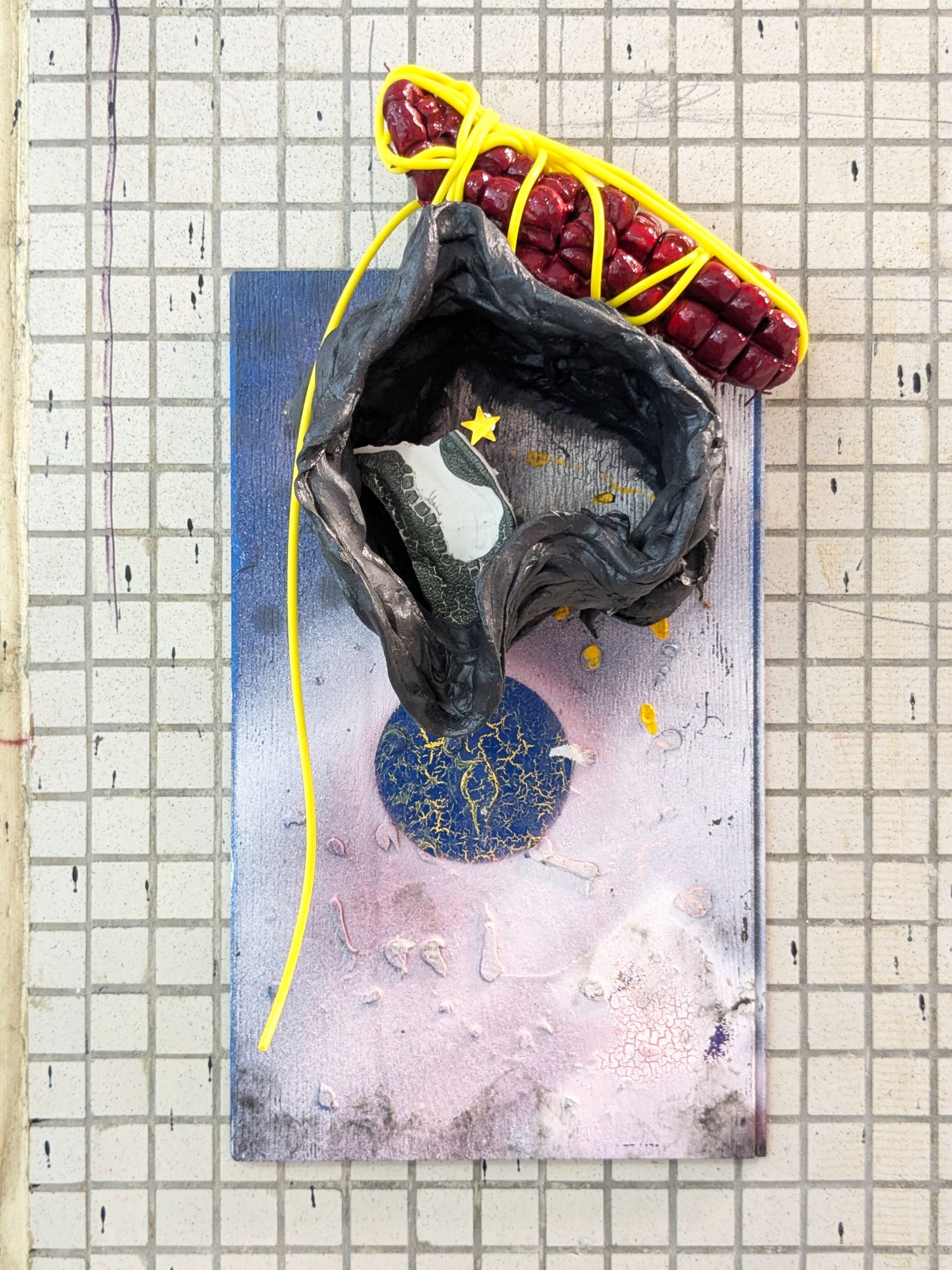 And Endogenidia was his name-o, 2025.
Materials: Epoxy, glazed ceramic, steel, sticker, flooring sample, rubber tube, paint, bungee cord.
